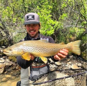 Tanner Lewis fishing guide with brown trout