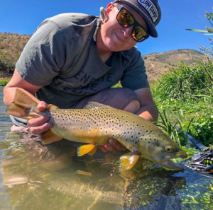 fly fishing guide Matthew Matkin with a brown trout