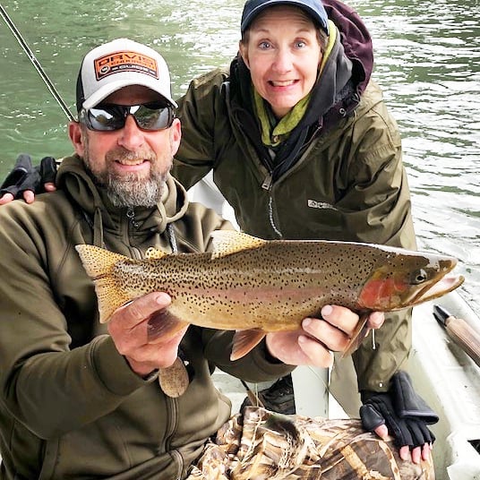 Fishing guide Jasson Pruett with client and trout
