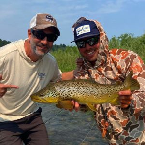 fishing guide tanner lewis with angler and brown trout