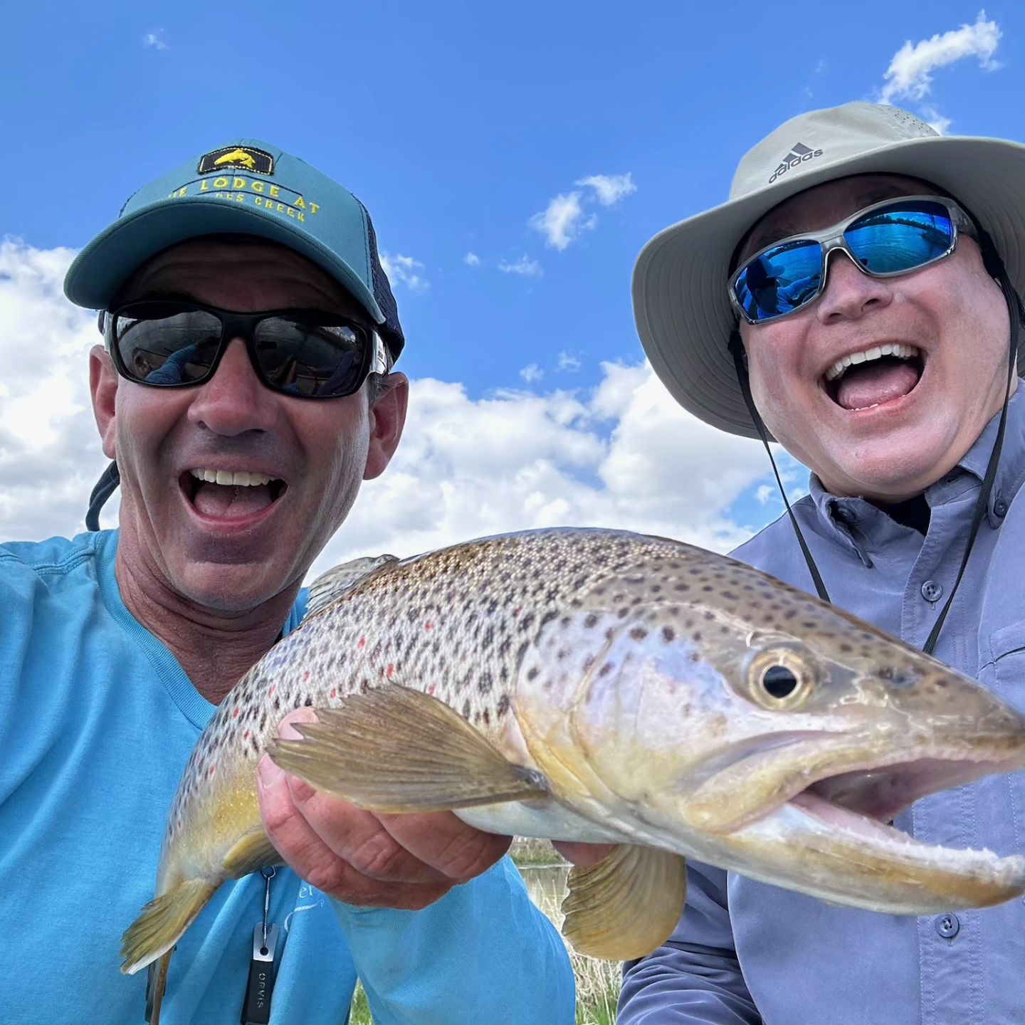 Fly fishing guide Josh Jablow with brown trout and his client.