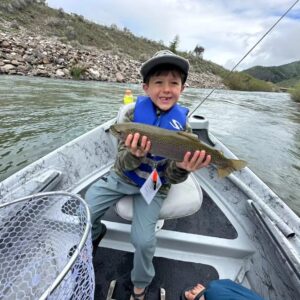 young fly fisher with a rainbow trout