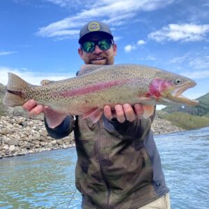 Fly Shop Manager Brody Barrus with a big Rainbow trout.