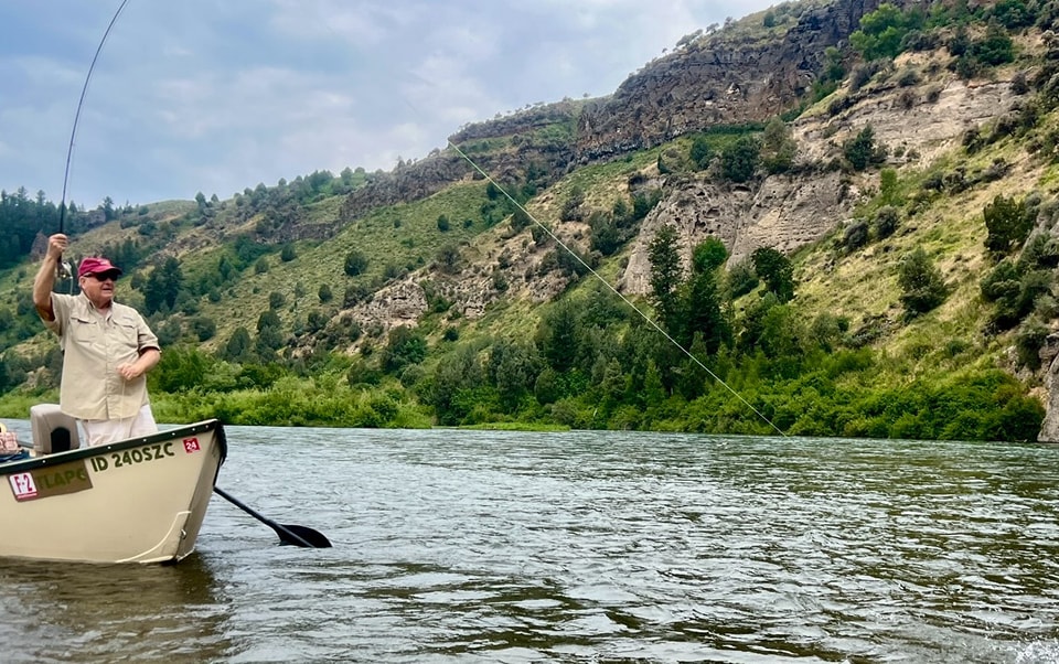 Angler with fish on. Fly fishing the South Fork of the Snake River