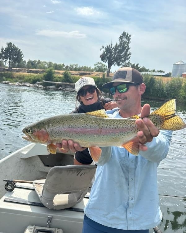 Fly Fishing Guide holds a Rainbow Trout on the South Fork of the Snake River