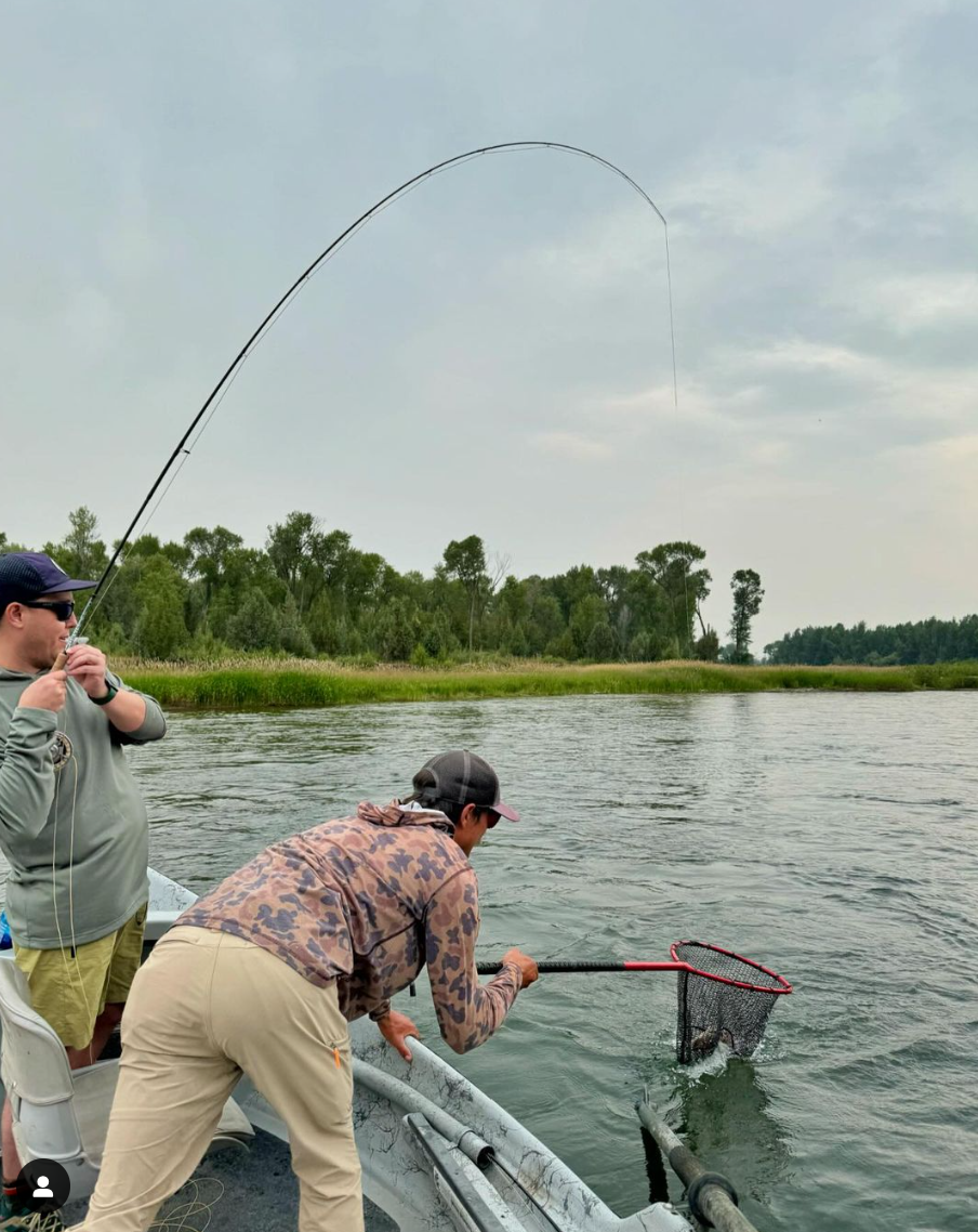 South Fork fly fishing guide netting a fish