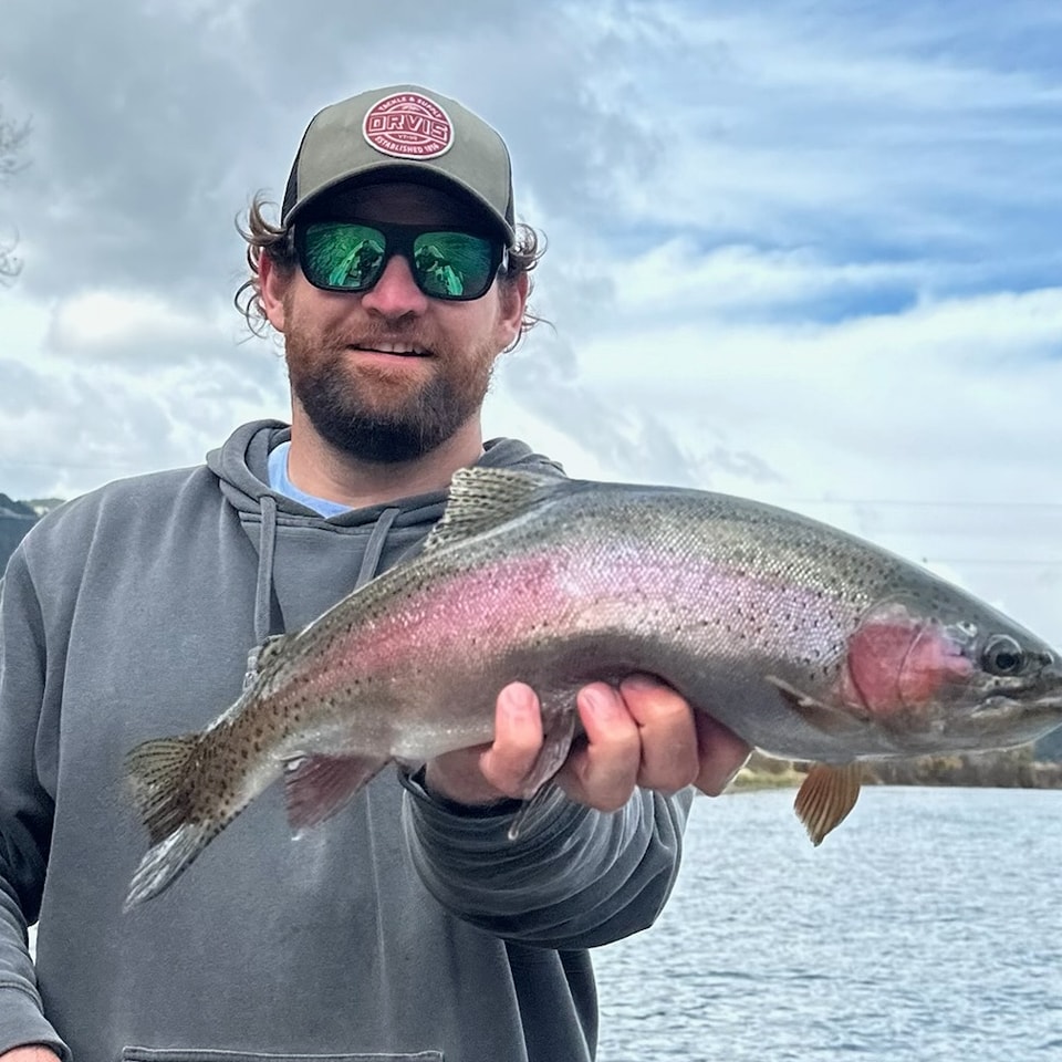 South Fork Fly Fisherman with a rainbow trout.