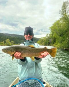 Big brown trout held by South Fork Angler