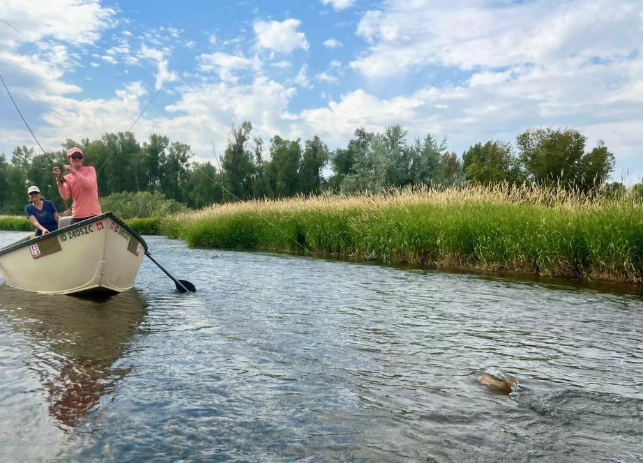 Drift Boat angler with a fish on.